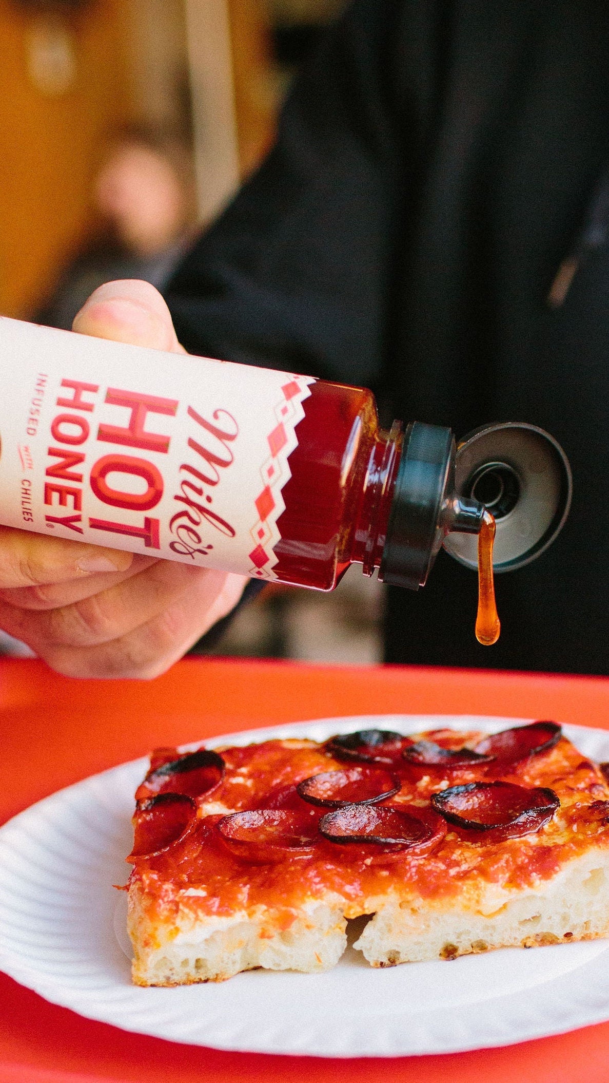 hot honey squeeze bottle with pizza